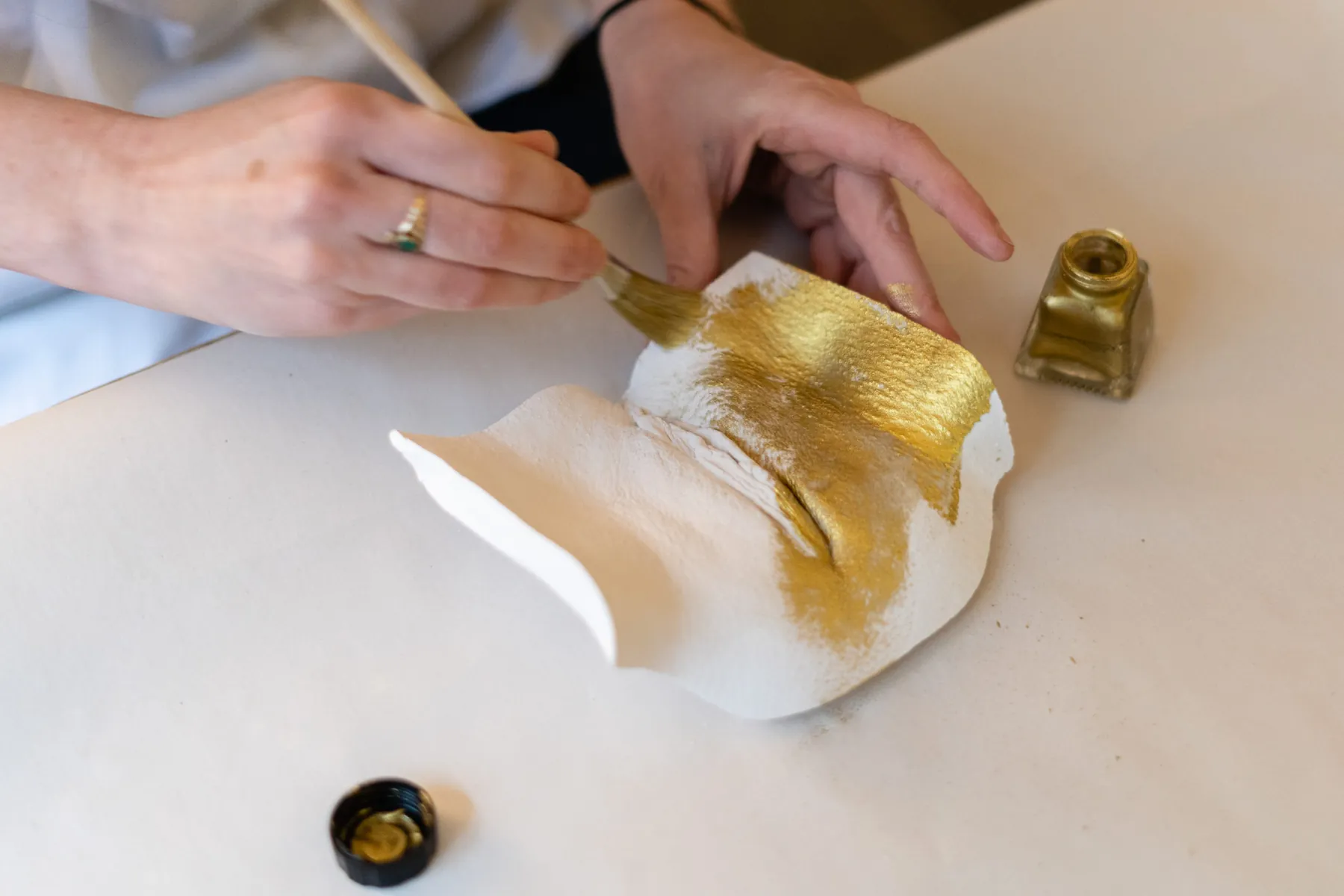 Gilding a plaster cast with gold leaf