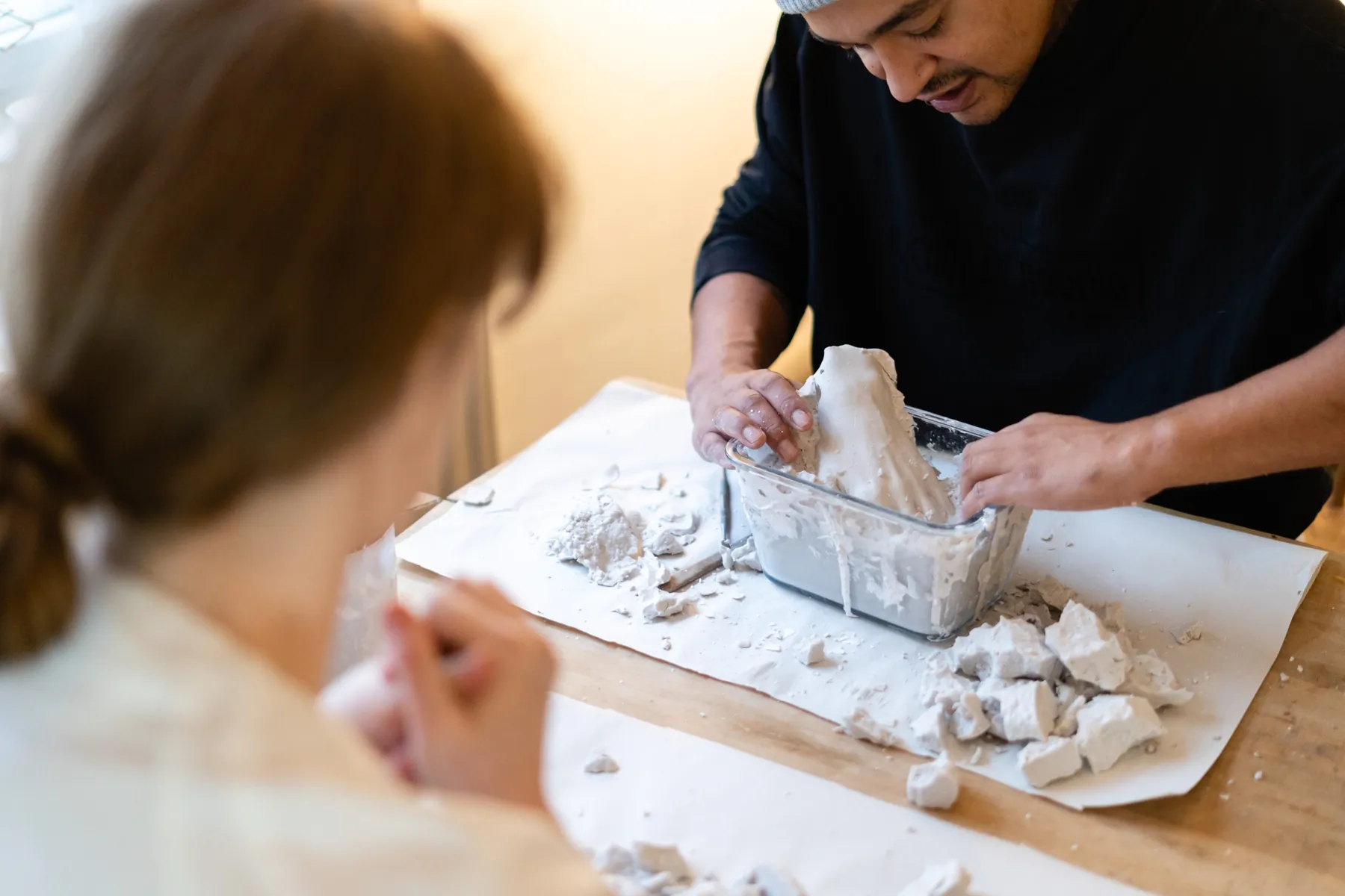 Brooke watching a participant refine a fresh plaster cast